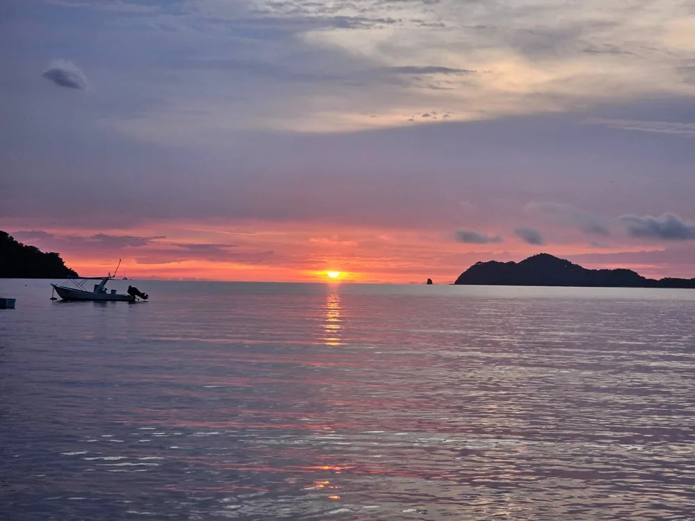 Playas del Coco bay and dive boats at sunset in Guanacaste